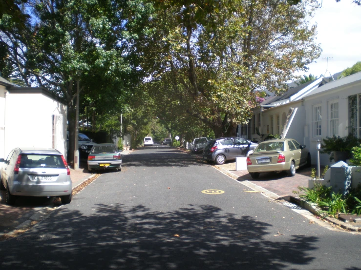 an older suburban street is full of parked cars