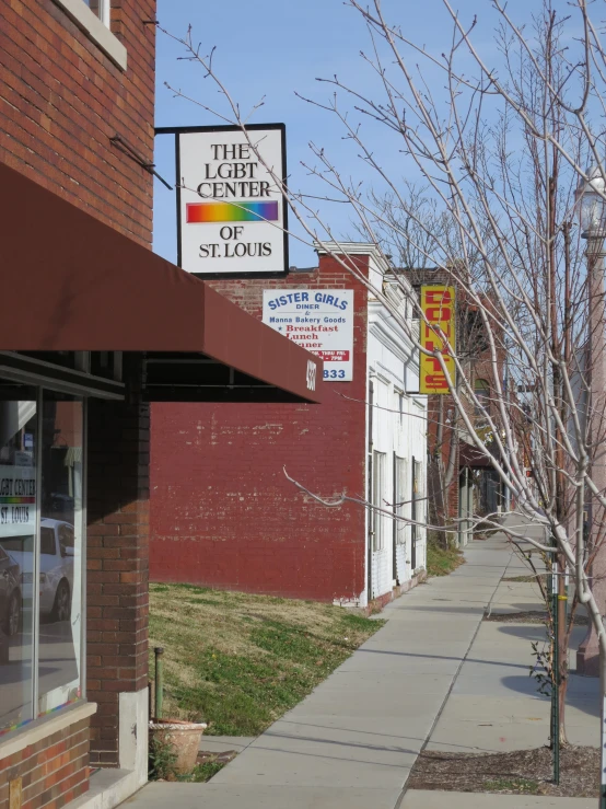 a sign for a business next to a sidewalk