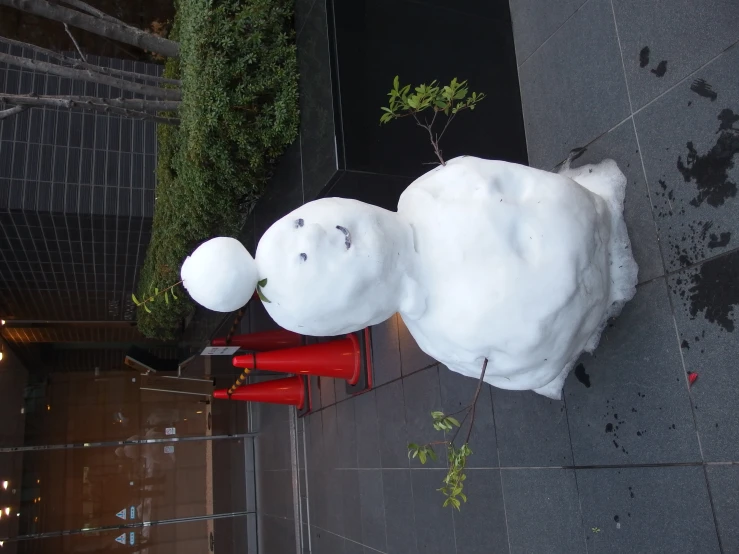 a snowman is shown on the street in front of a building