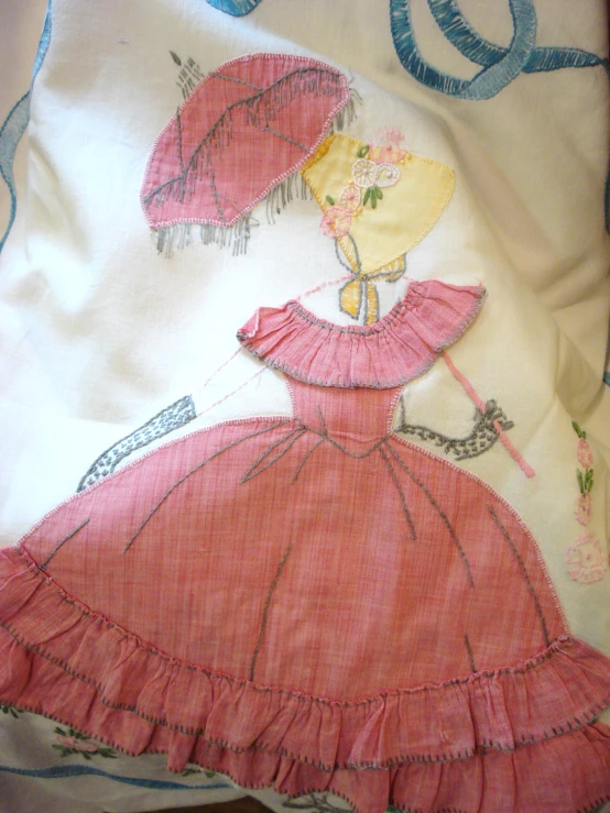 there is an old - fashioned, pink dress and umbrella on a bed