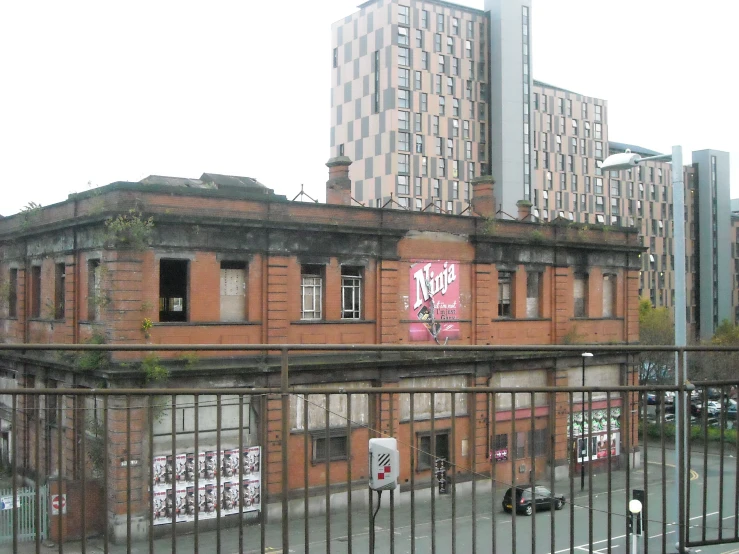 an old building with graffiti on the side and on the other side