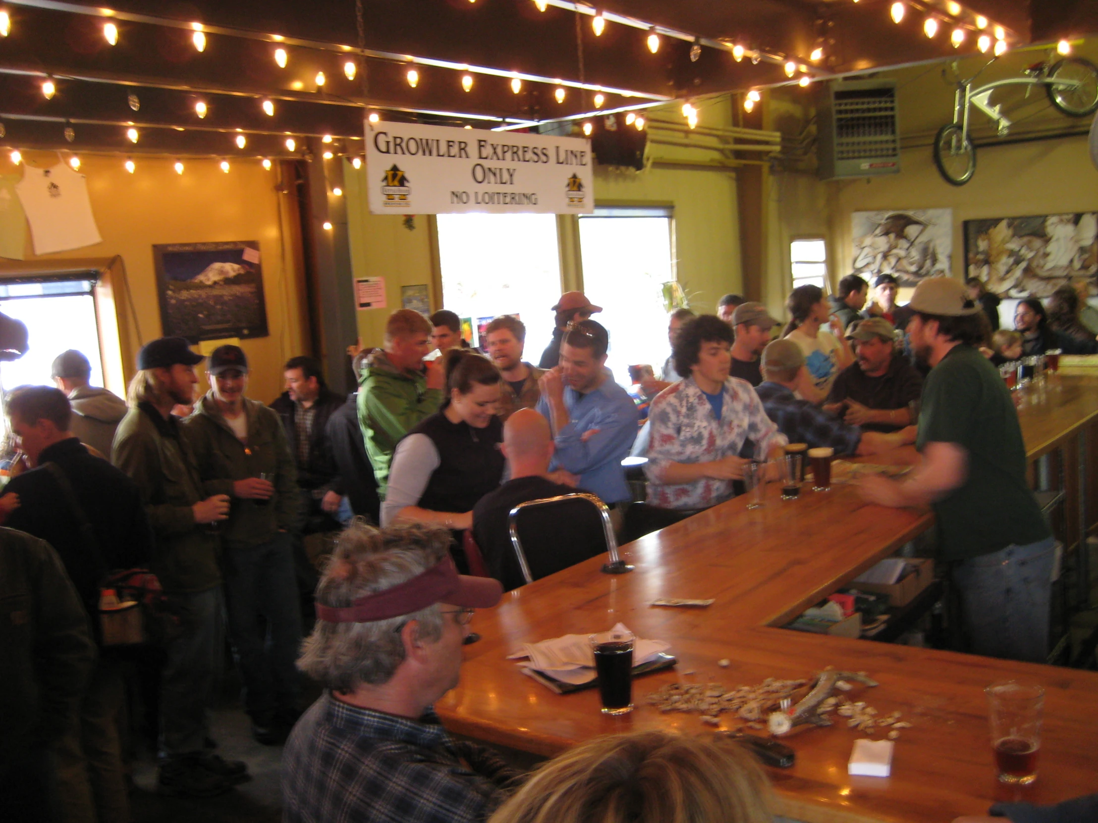 a group of people standing around a table filled with wine