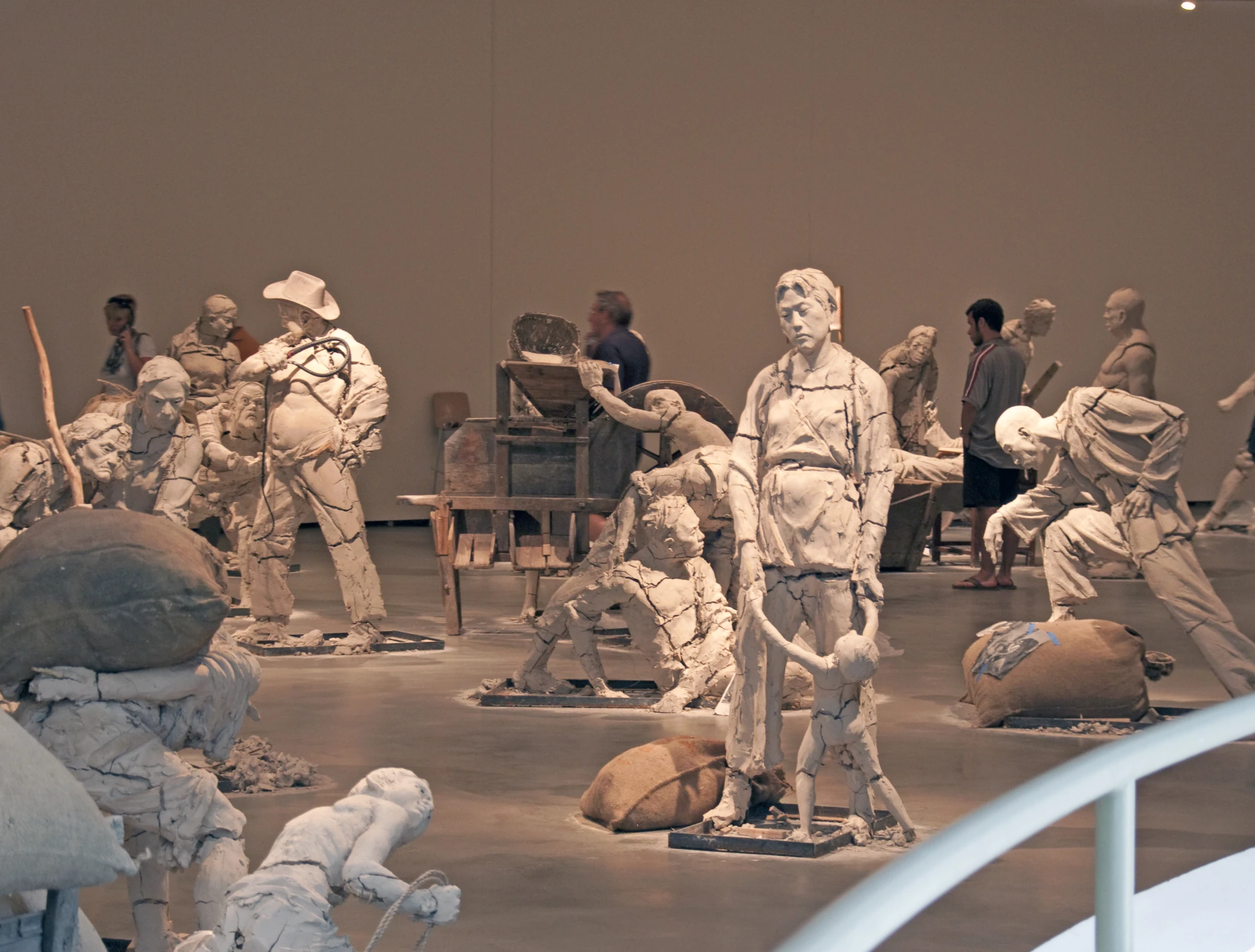 several sculptures on a floor in front of a wall