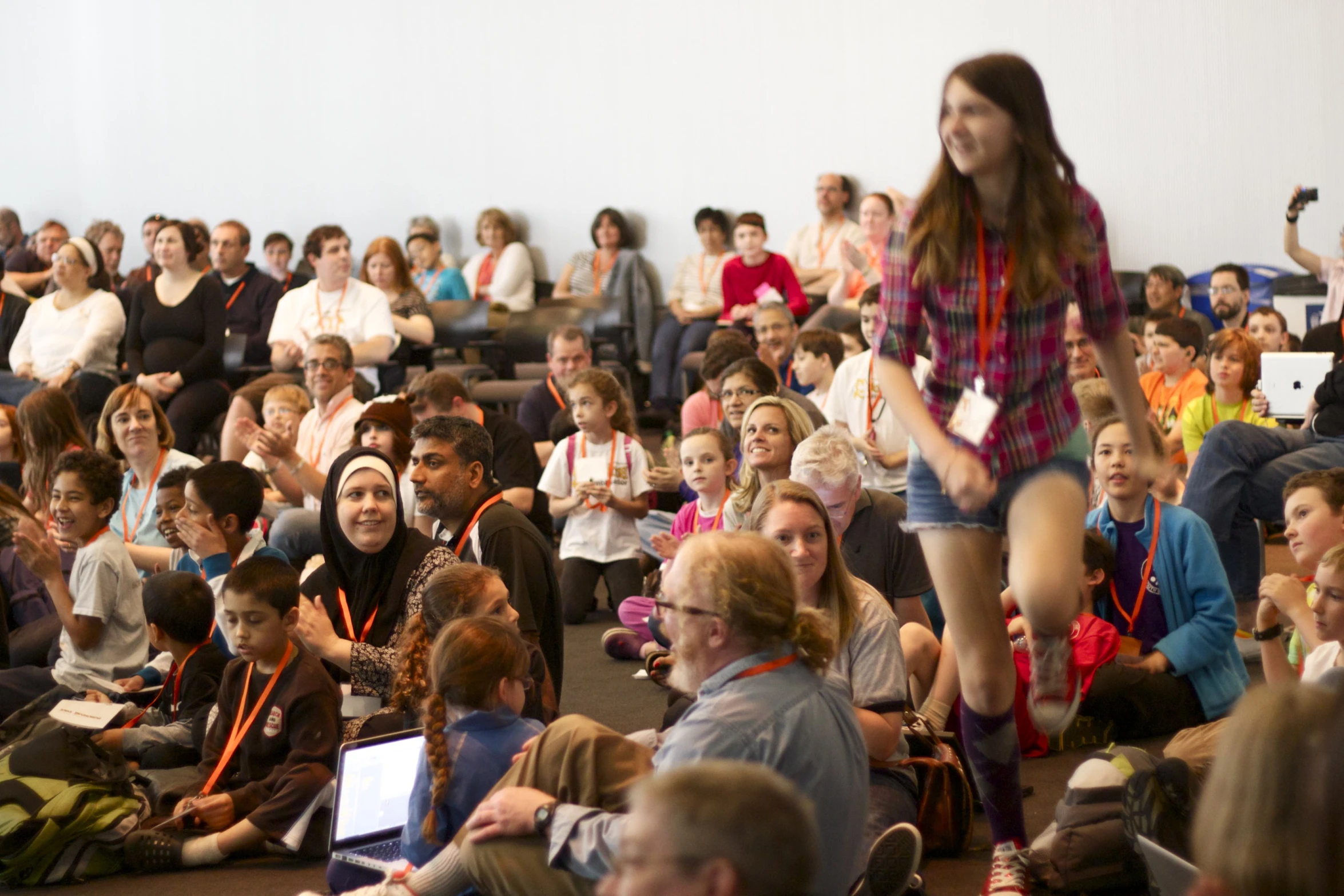 a bunch of people are watching as one person walks down the runway