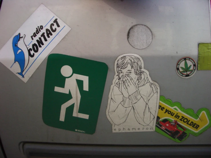 several different stickers on the back of a refrigerator