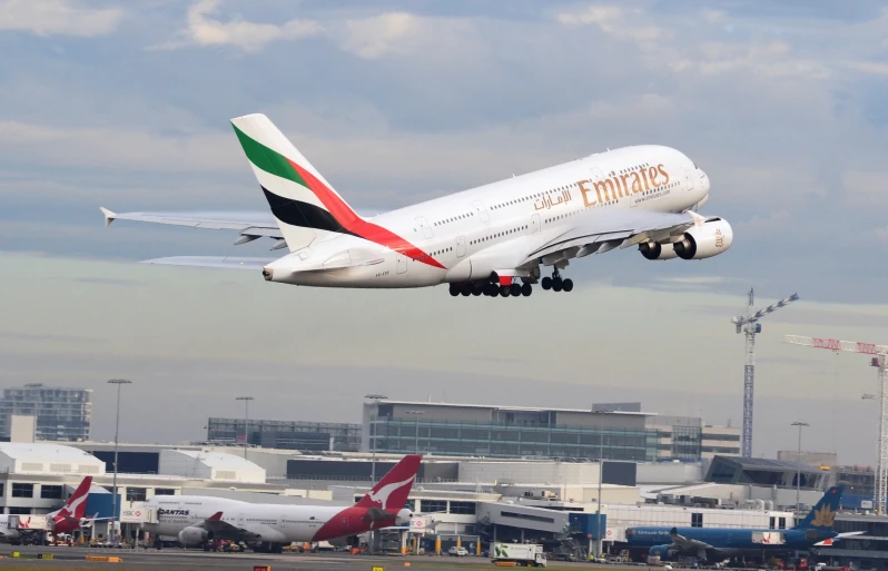 a passenger jet takes off with it's landing gear down