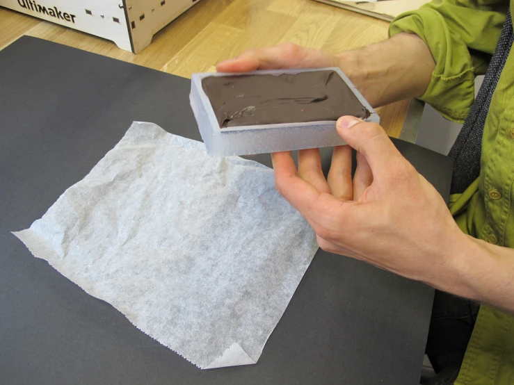 a person is opening a box on top of a table