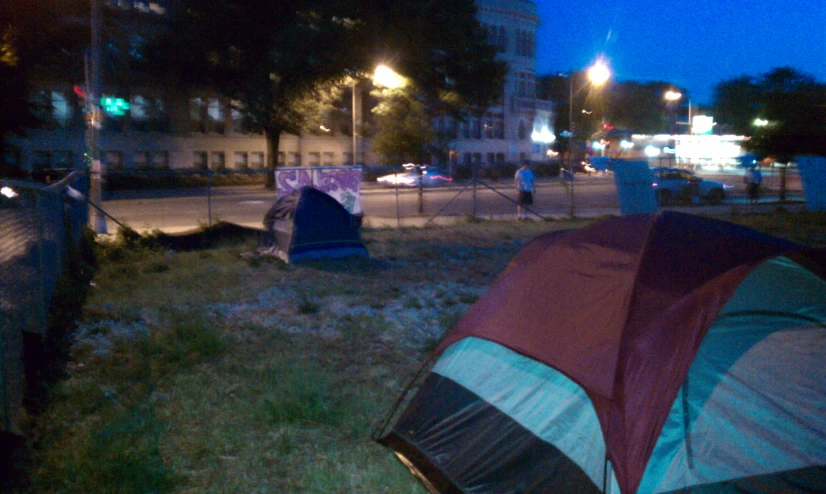 a tent and some people at night in the park