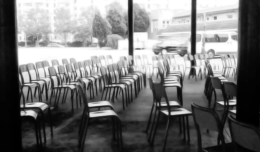 a room with a large window and chairs lined up