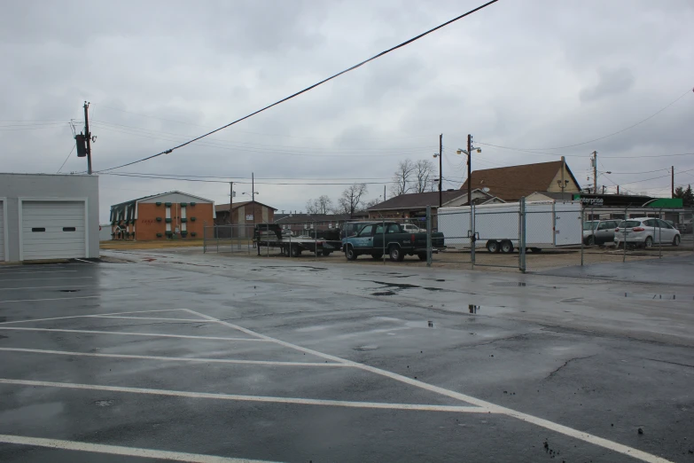 an empty parking lot in front of some buildings