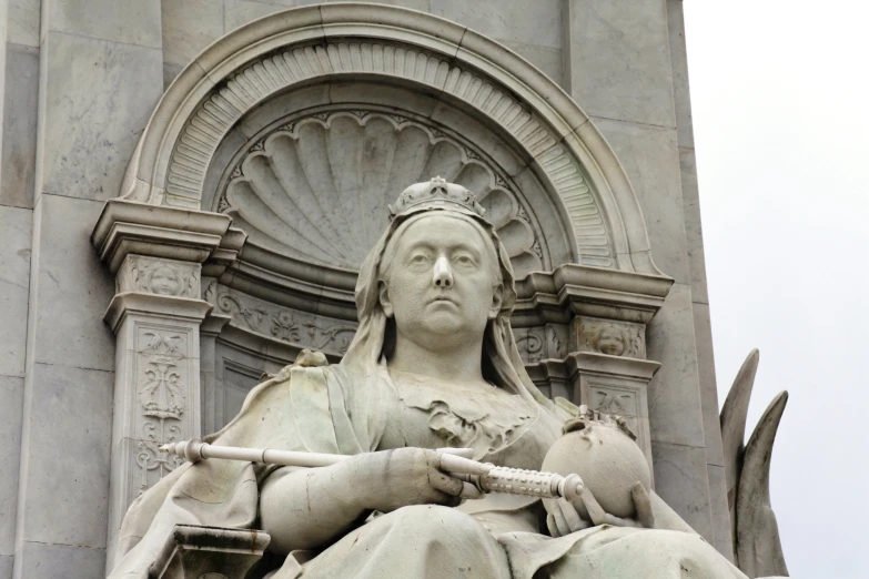 a statue of a woman sitting on the back of a horse