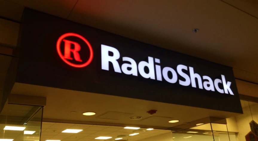 the radio shack logo is lit up in front of the store