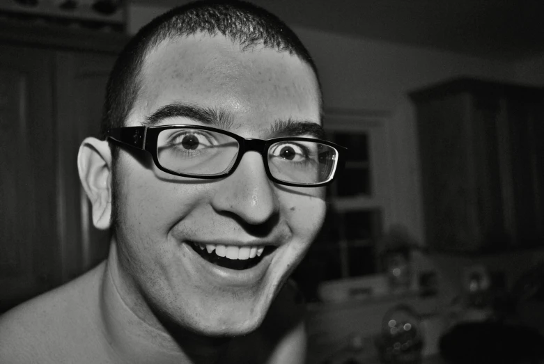 an image of man smiling with glasses on