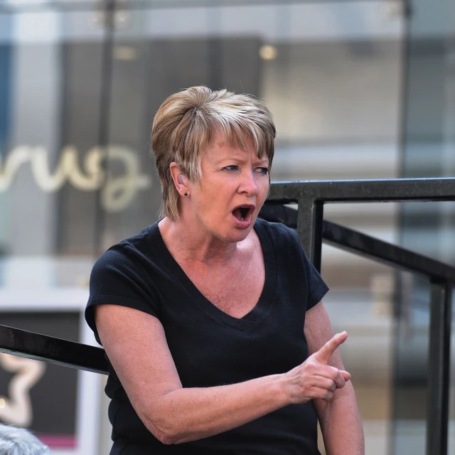 a woman holding her finger open at the camera