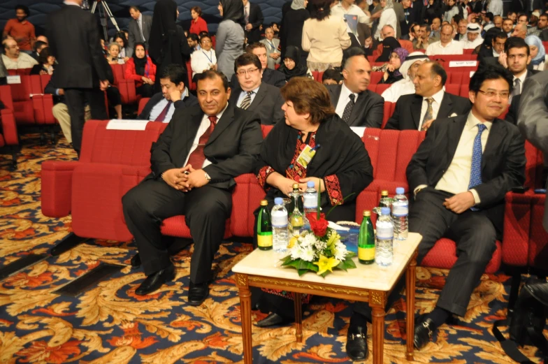 a room full of people sitting in couches during a conference