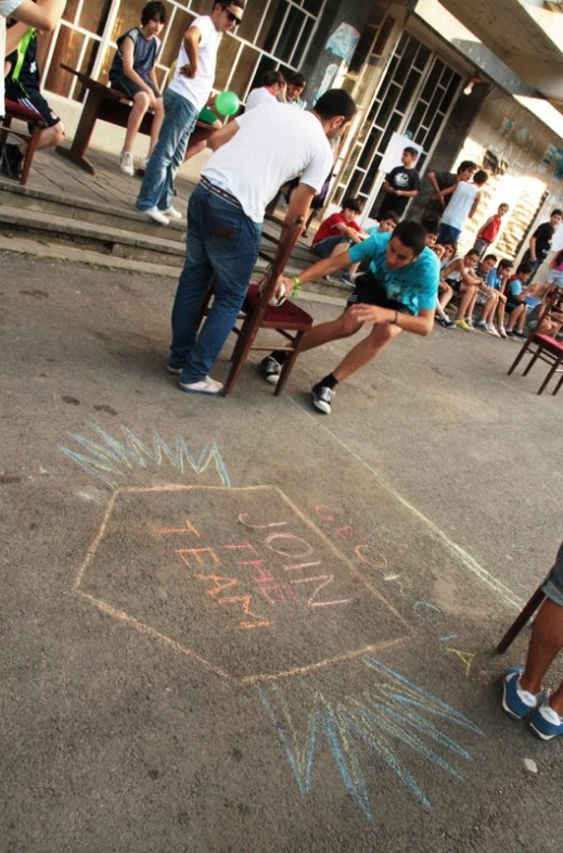 a person has a chalk drawing on the sidewalk