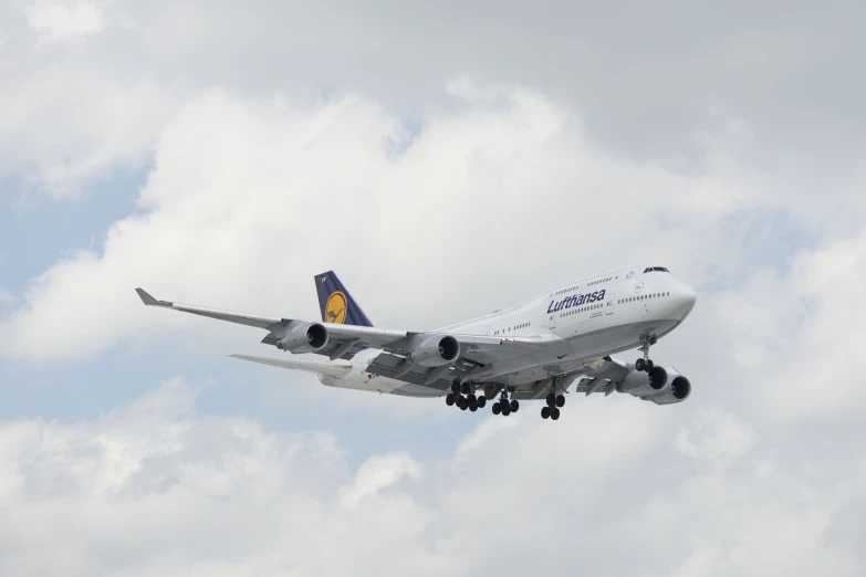 large jet airliner on landing in cloudy skies