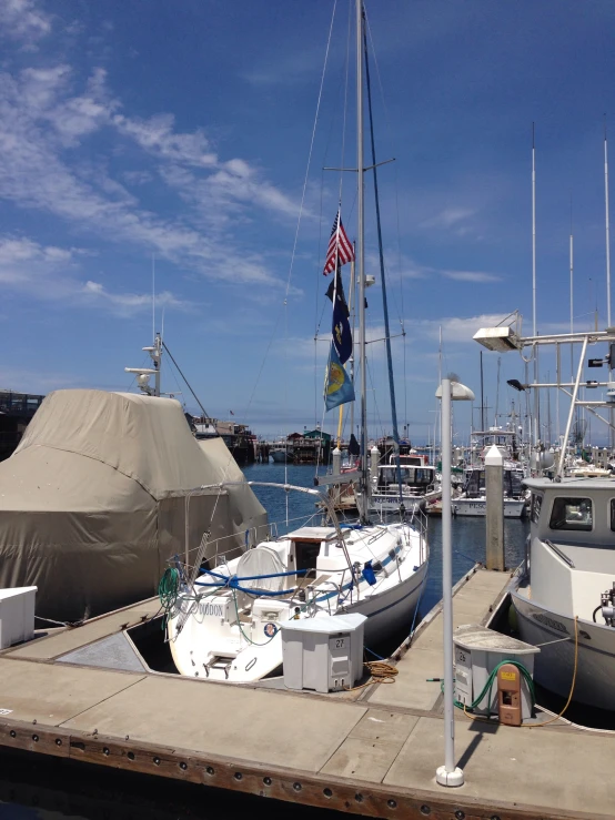 there are boats docked at the harbor in the daytime