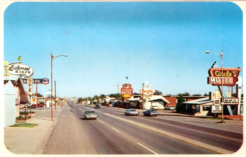 cars driving down a road in front of a restaurant