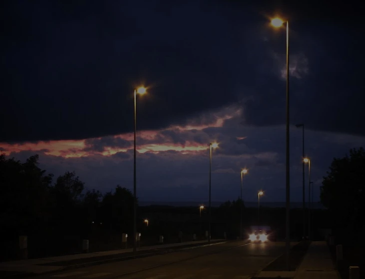 the road lights shine brightly at night time