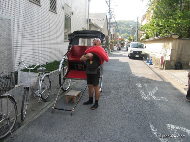 a man standing on the sidewalk next to his bike