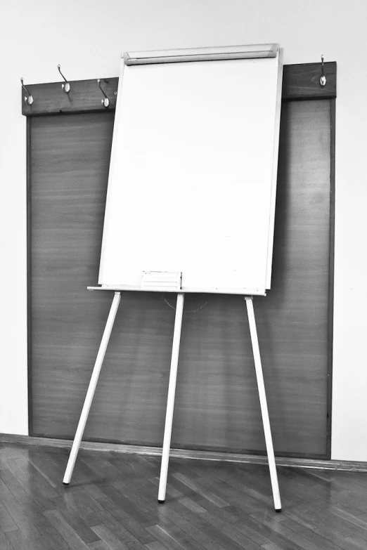 an easel with a white board on top of it