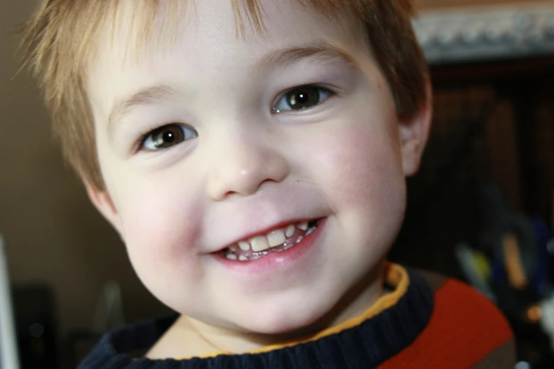 a child is looking at the camera with smile