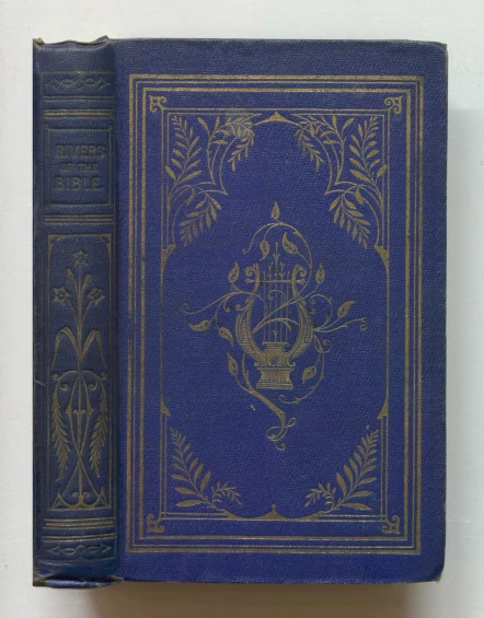 an old blue and gold book is being displayed