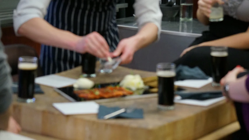 a woman prepares to put toppings on her food