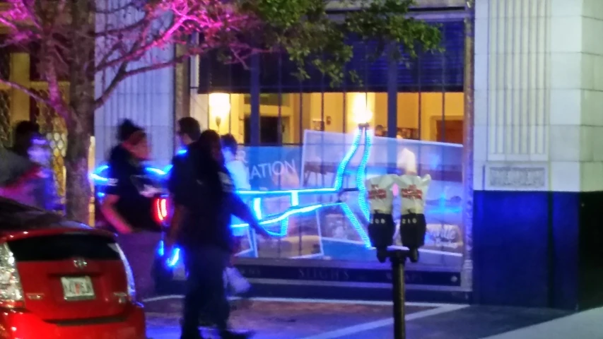 people walking down the sidewalk near a building