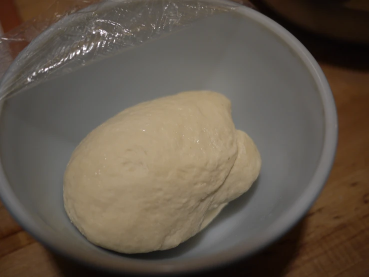 a ball of dough sitting in a bowl
