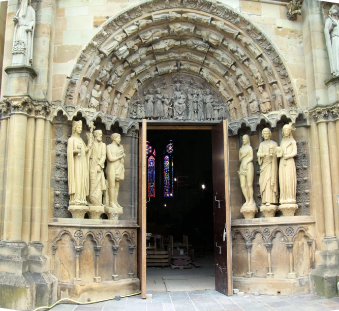 a gothic cathedral with sculptures depicting religious people