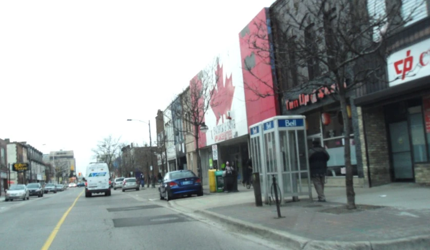 some cars and people on a city street