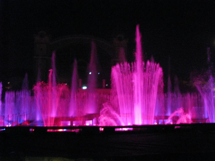 a close up of several jets of water at night