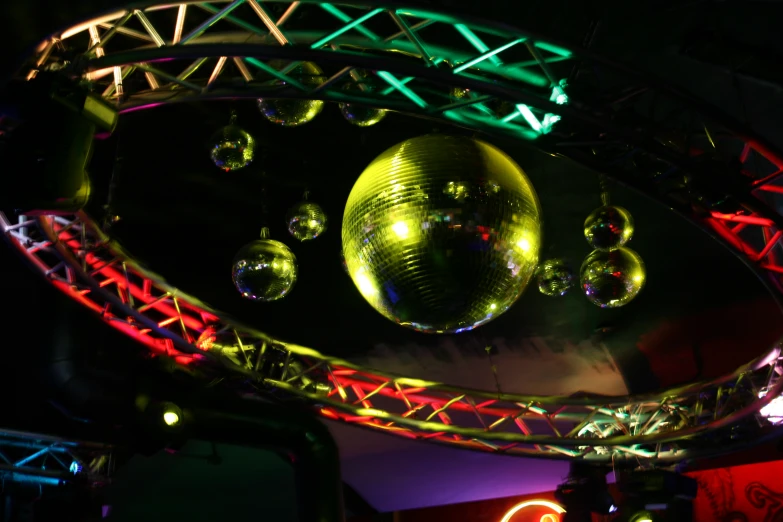 a couple of shiny disco balls with lights all around