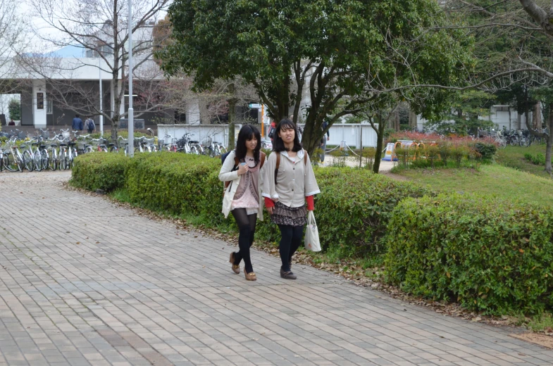 two s walking together with one carrying an umbrella