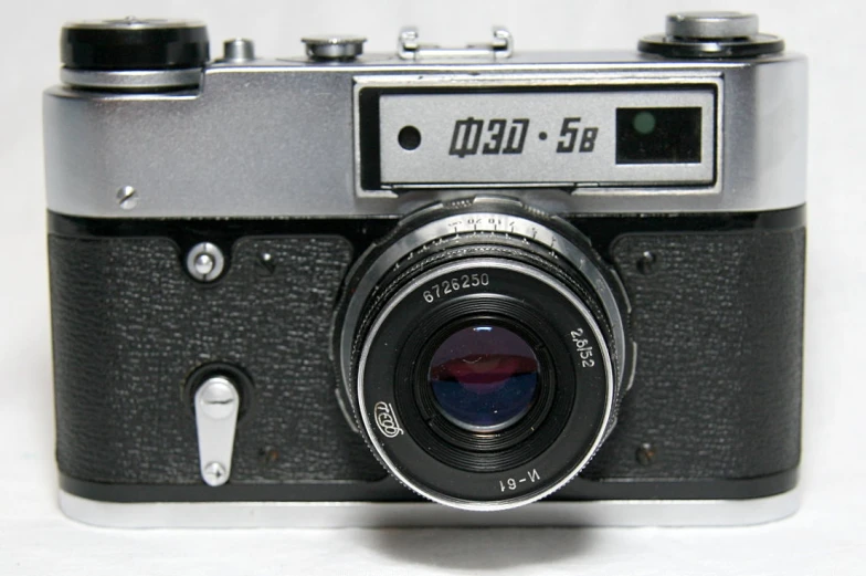 a black and gray camera on a white table