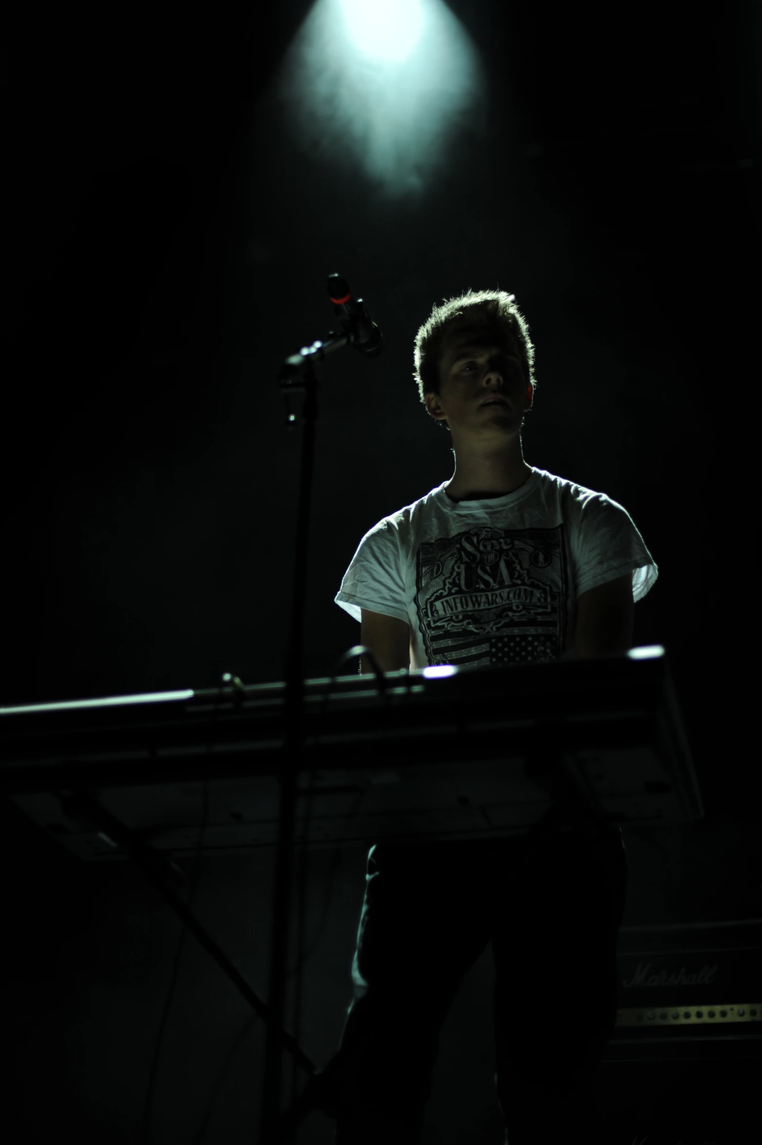 a man standing on a stage at night