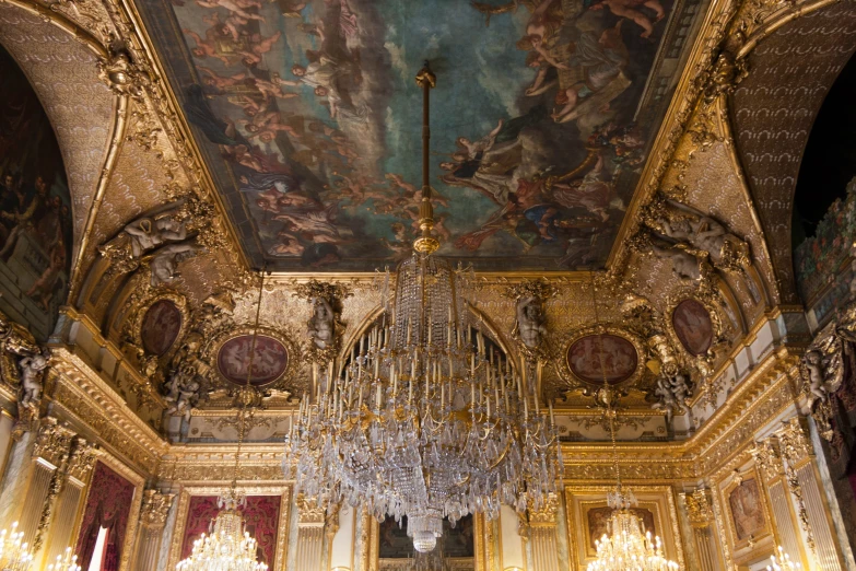 a fancy chandelier and chandeliers in a gold, marble and ornate building