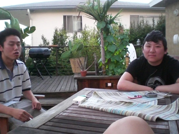 a boy and his friend are outside having a conversation