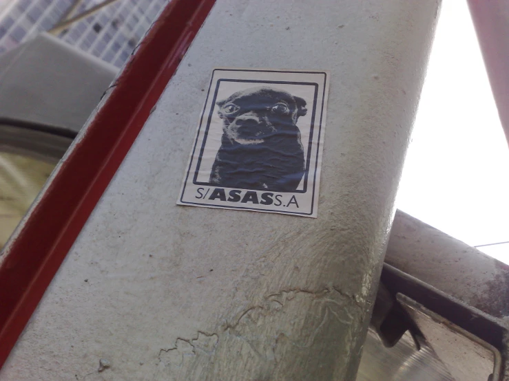 a sticker of a dog with a beard on a pole