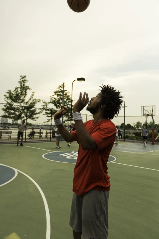 a man tossing a ball up into the air