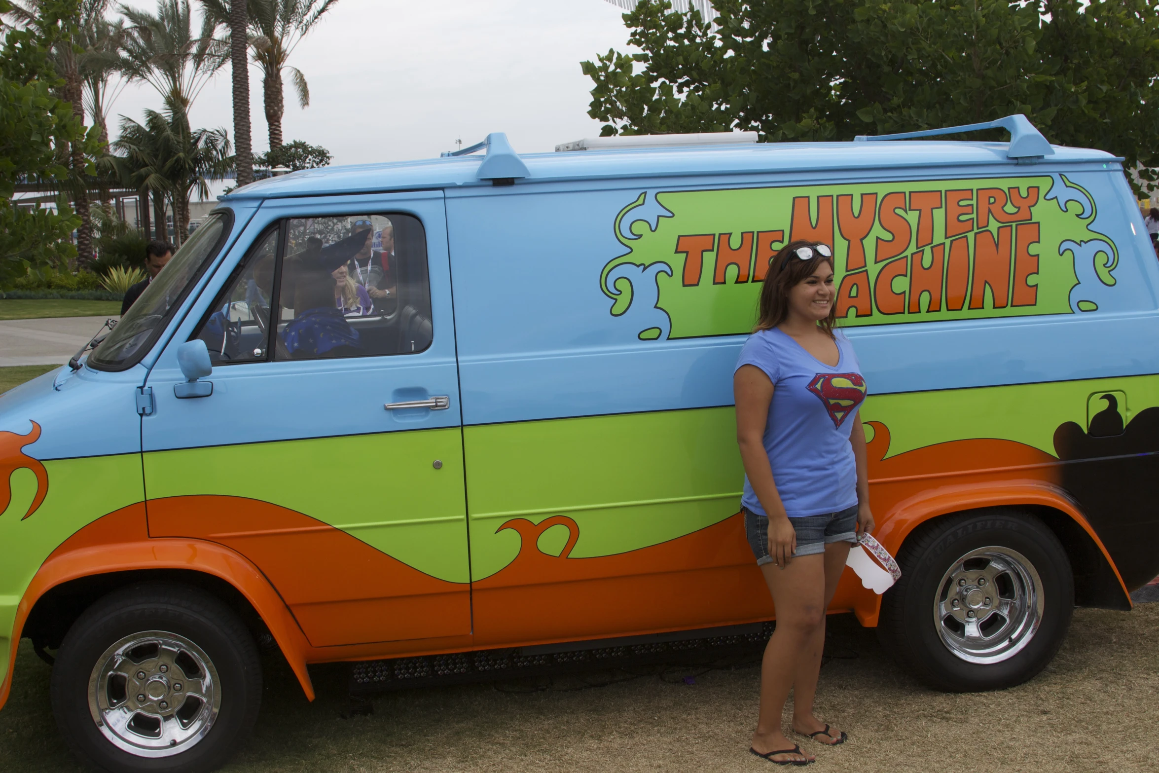 a woman poses with her van for a picture