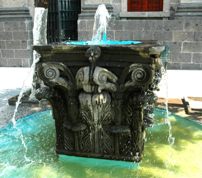 a water fountain with a statue in the middle