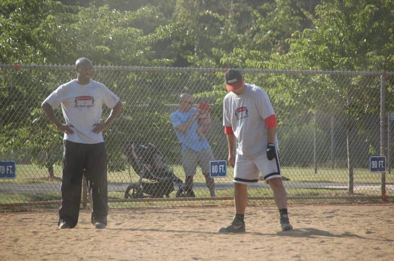 a group of men playing baseball on top of a field