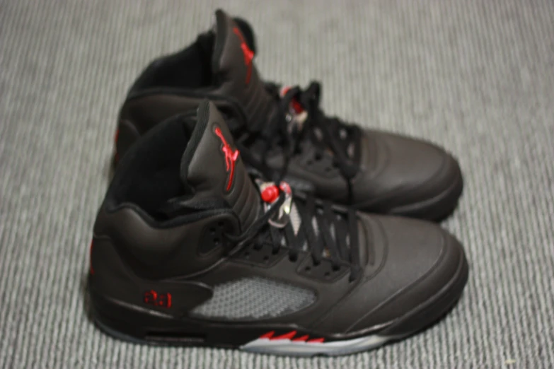 the air jordan is black and red on the ground