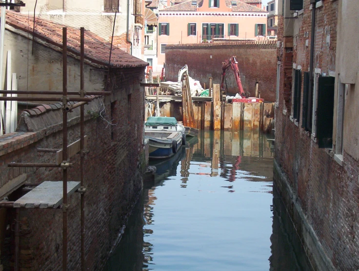 boats in a waterway with buildings behind them