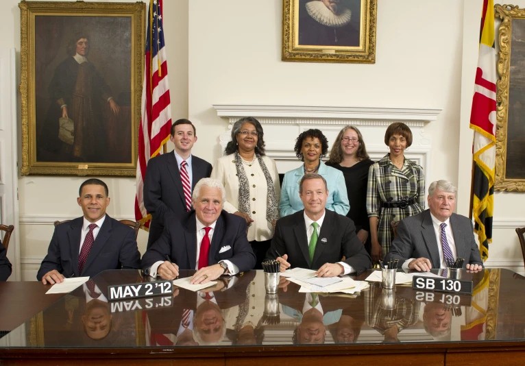 an official meeting with several people in front of the white house desk