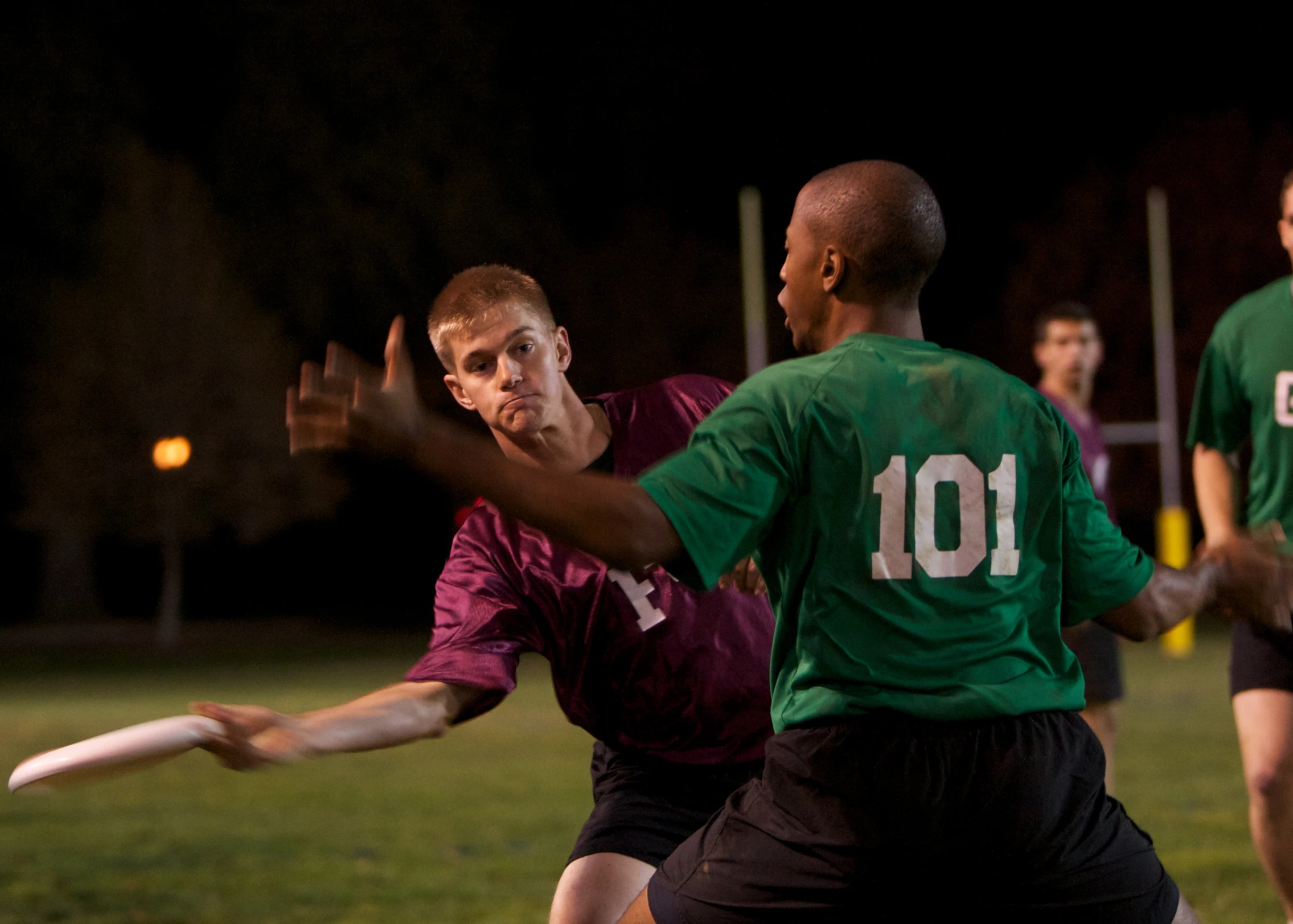 young men playing in a game of frisbee