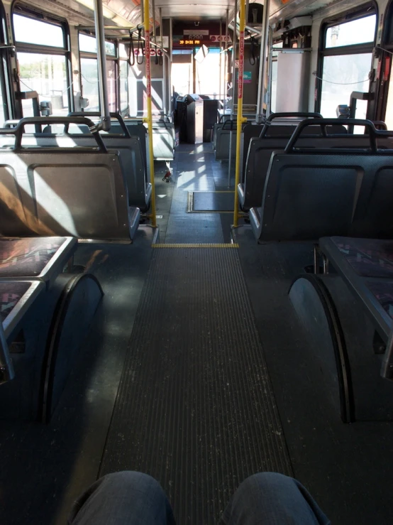 an empty train car with empty benches and other seats